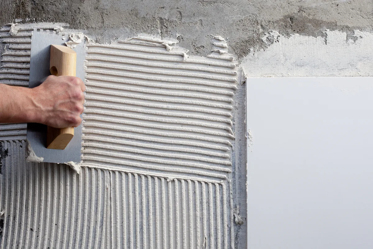 Plasterer applying render to an external wall
